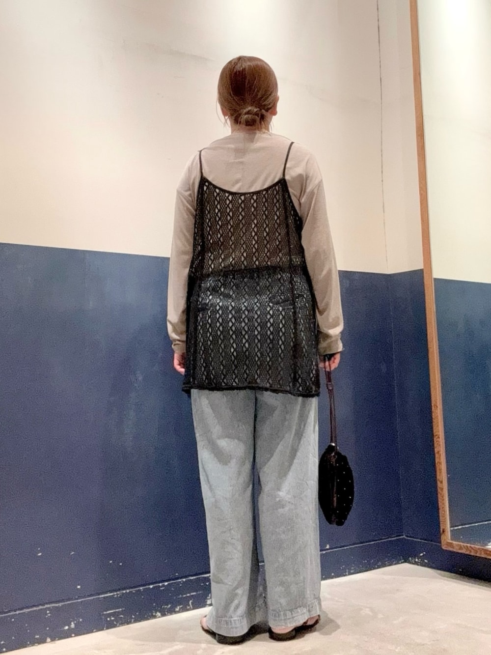 ブラック系のサンダル、ブルー系のデニムパンツ、ベージュ系のTシャツ/カットソーを着用したレディースの夏コーディネートの3枚目の写真