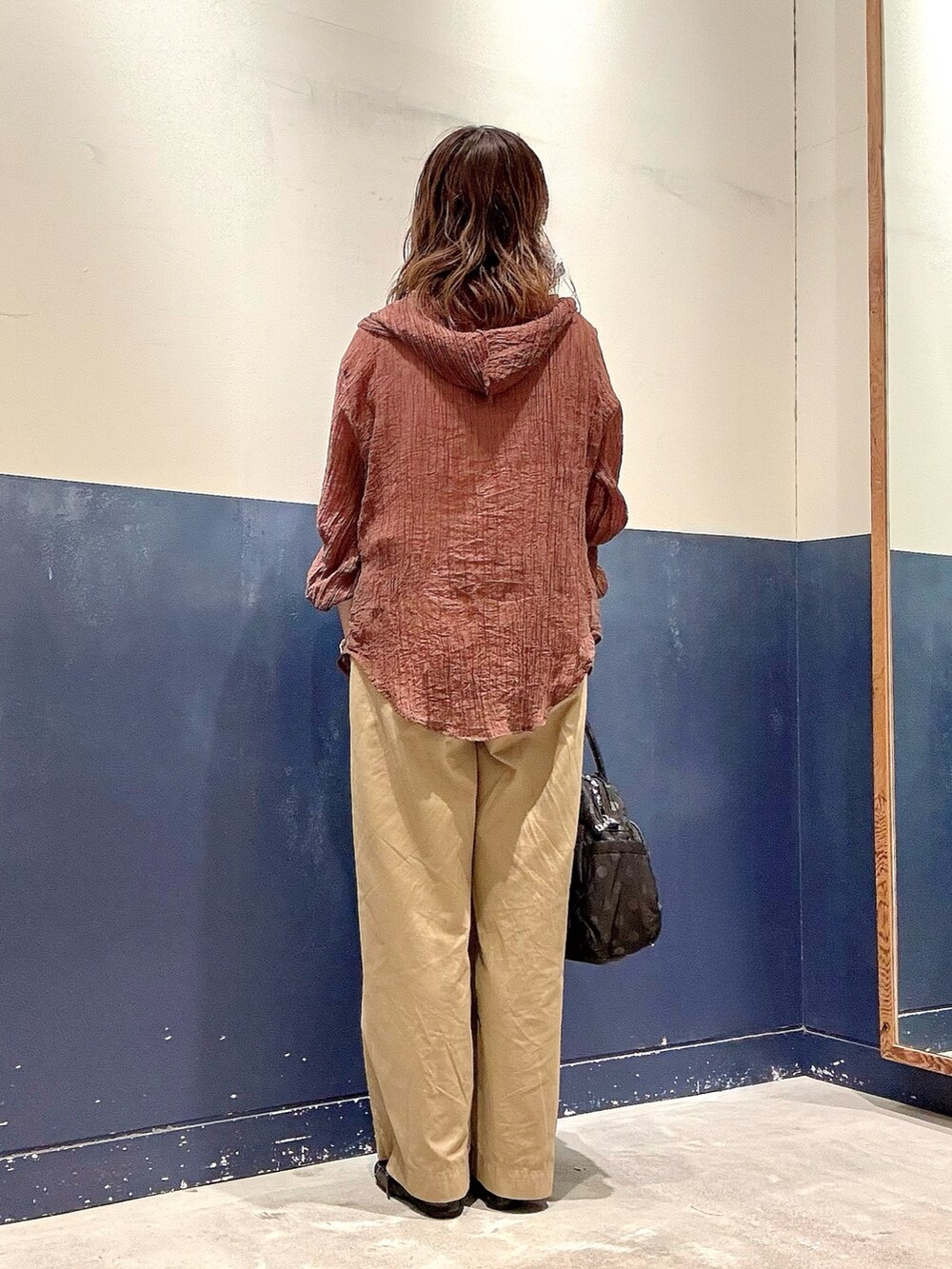 ブラック系のパンプス、ブラック系のショルダーバッグ、ホワイト系のタンクトップを着用したレディースの夏コーディネートの3枚目の写真