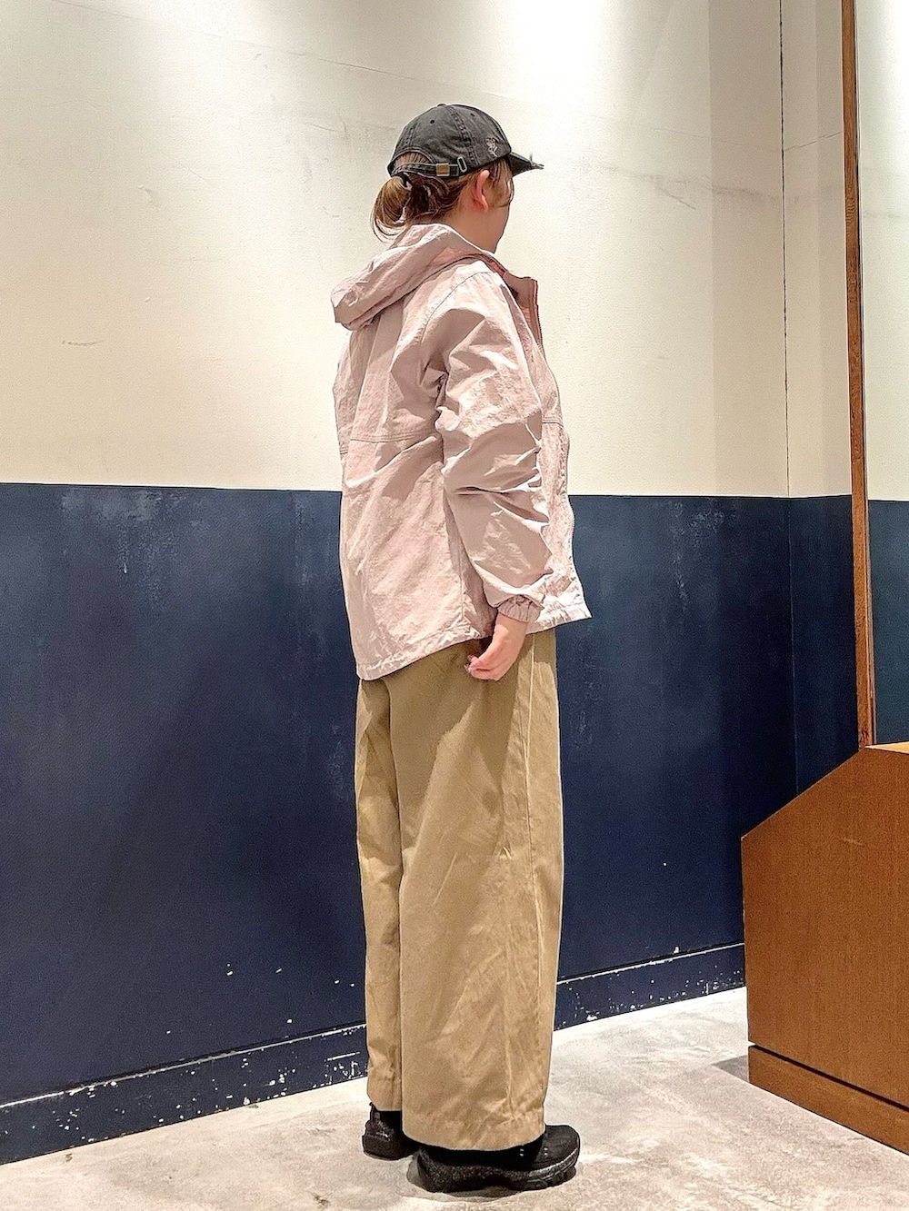 ピンク系のマウンテンパーカー、グレー系のスウェット、ブラック系のスニーカーを着用したレディースの冬コーディネートの2枚目の写真