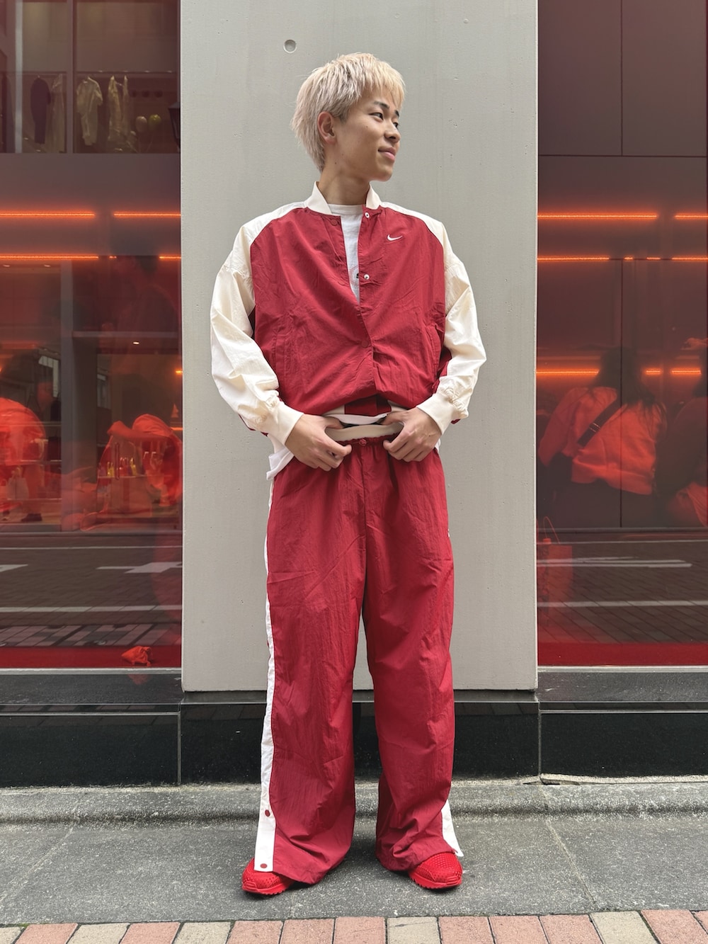レッド系のブルゾン、レッド系のスニーカーを着用したメンズの春コーディネートの2枚目の写真