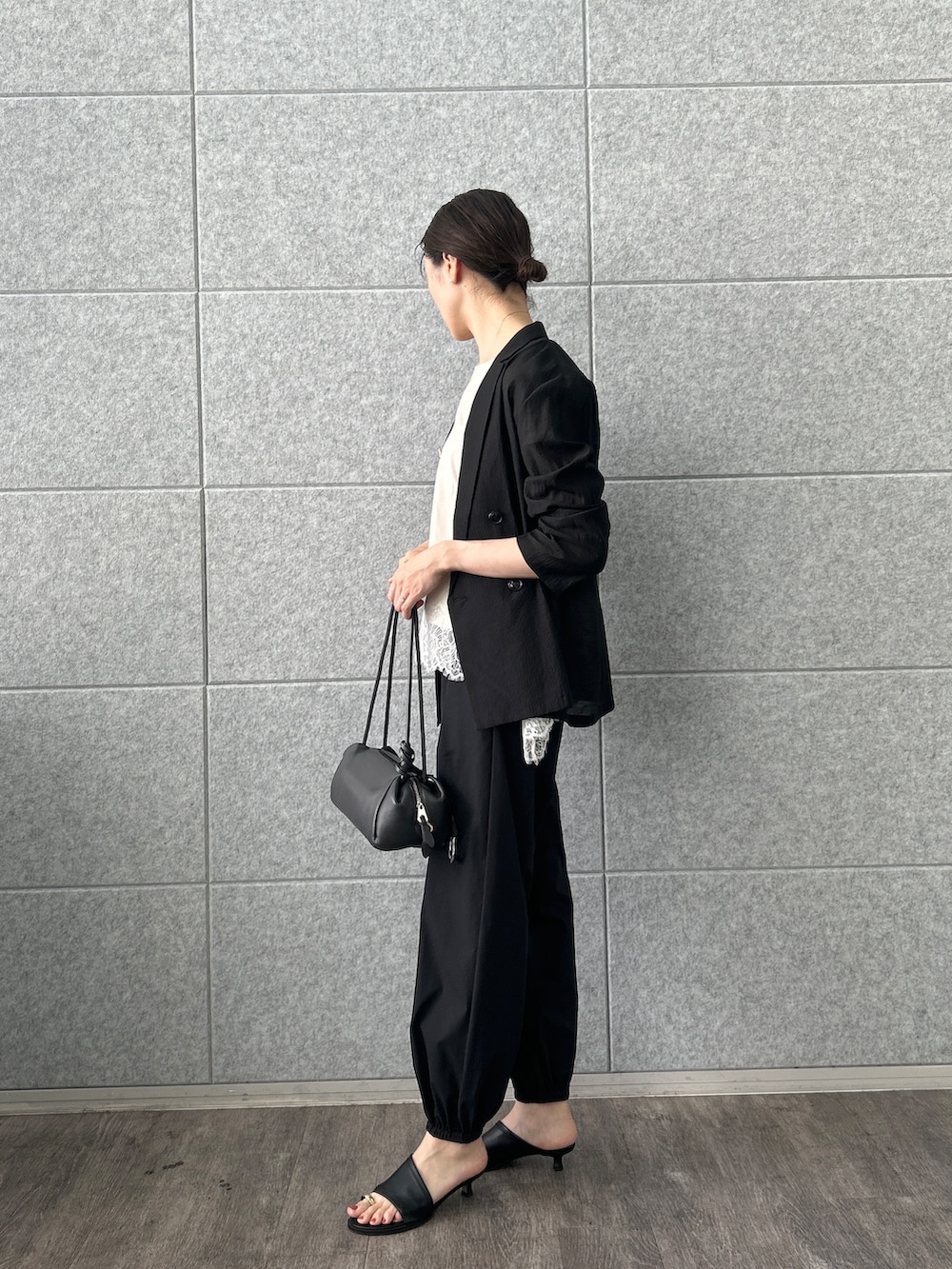 ベージュ系のTシャツ/カットソー、ブラック系のテーラードジャケット、ブラック系のその他パンツを着用したレディースの夏コーディネートの5枚目の写真