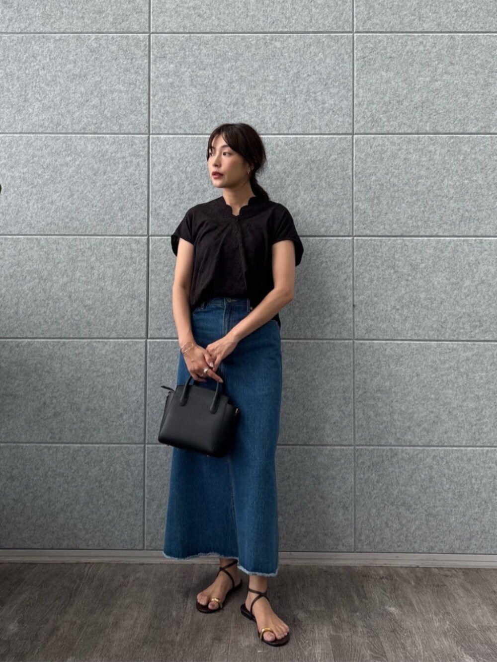 ブルー系のデニムスカート、ブラック系のTシャツ/カットソーを着用したレディースの夏コーディネートの2枚目の写真
