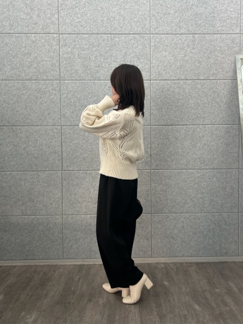 ブラック系のその他パンツ、ホワイト系のニット/セーターを着用したレディースの冬コーディネートの3枚目の写真