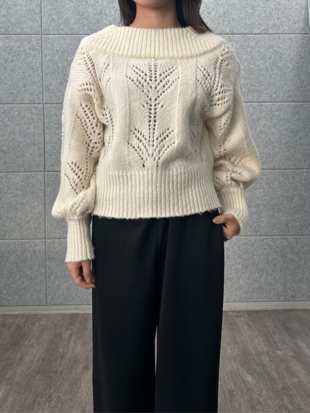 ブラック系のその他パンツ、ホワイト系のニット/セーターを着用したレディースの冬コーディネートの6枚目の写真