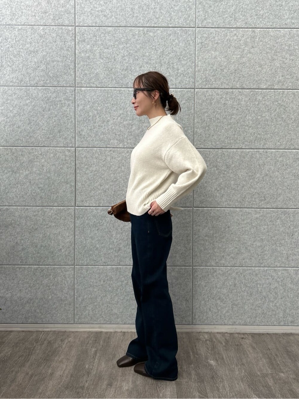 ホワイト系のニット/セーター、ブルー系のデニムパンツを着用したレディースの冬コーディネートの3枚目の写真