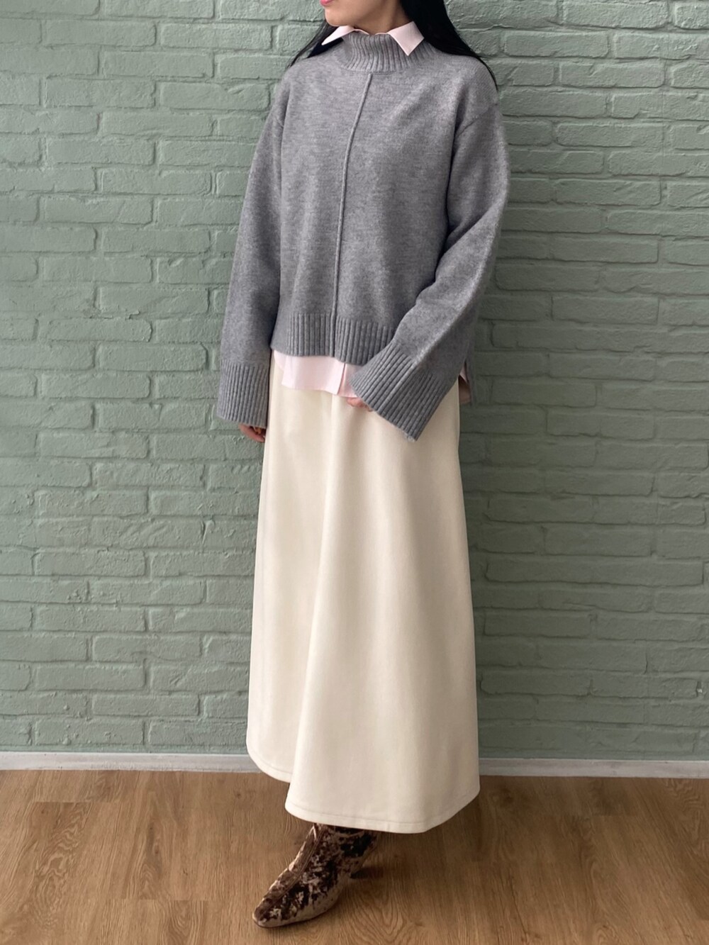 ホワイト系のスカート、グレー系のニット/セーター、ピンク系のシャツ/ブラウスを着用したレディースの秋コーディネートの3枚目の写真