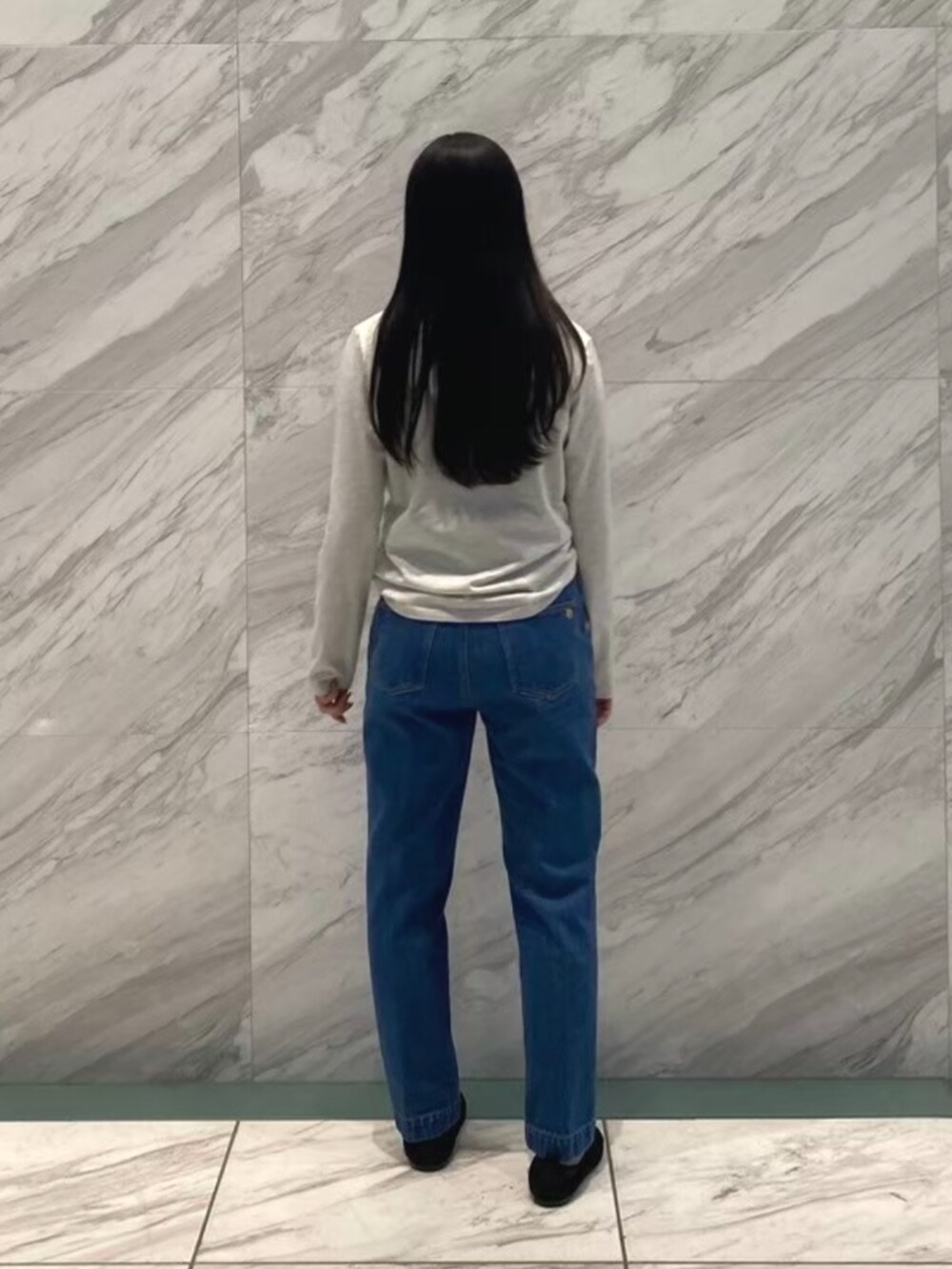 ブルー系のデニムパンツ、グレー系のTシャツ/カットソーを着用したレディースの冬コーディネートの5枚目の写真