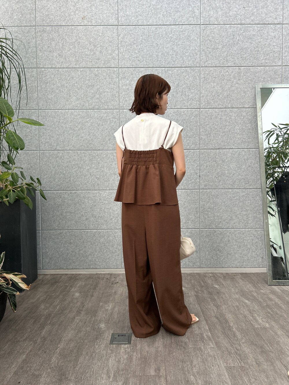 ホワイト系のニット/セーター、ブラウン系のサロペット/オーバーオールを着用したレディースの夏コーディネートの5枚目の写真