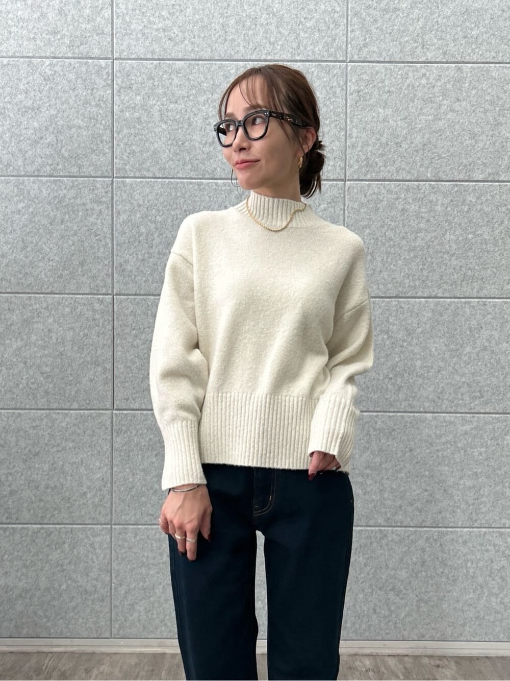ホワイト系のニット/セーター、ブルー系のデニムパンツを着用したレディースの冬コーディネートの8枚目の写真
