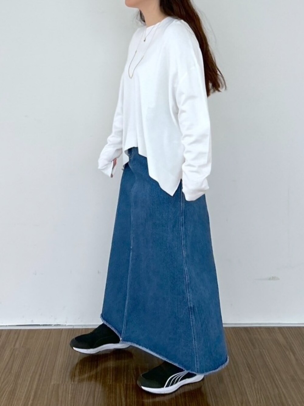 ブルー系のデニムスカート、ホワイト系のニット/セーターを着用したレディースの春コーディネートの5枚目の写真