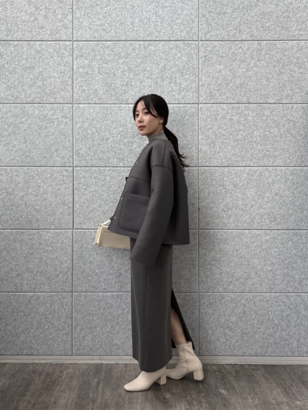 グレー系のニット/セーター、グレー系のワンピース、グレー系のブルゾンを着用したレディースの秋コーディネートの6枚目の写真