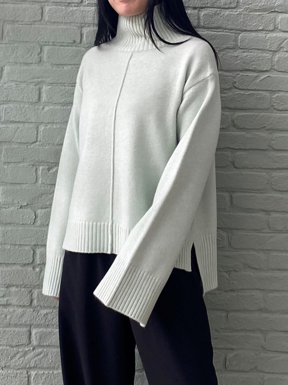 ブラック系のその他パンツ、グリーン系のニット/セーターを着用したレディースの秋コーディネートの6枚目の写真