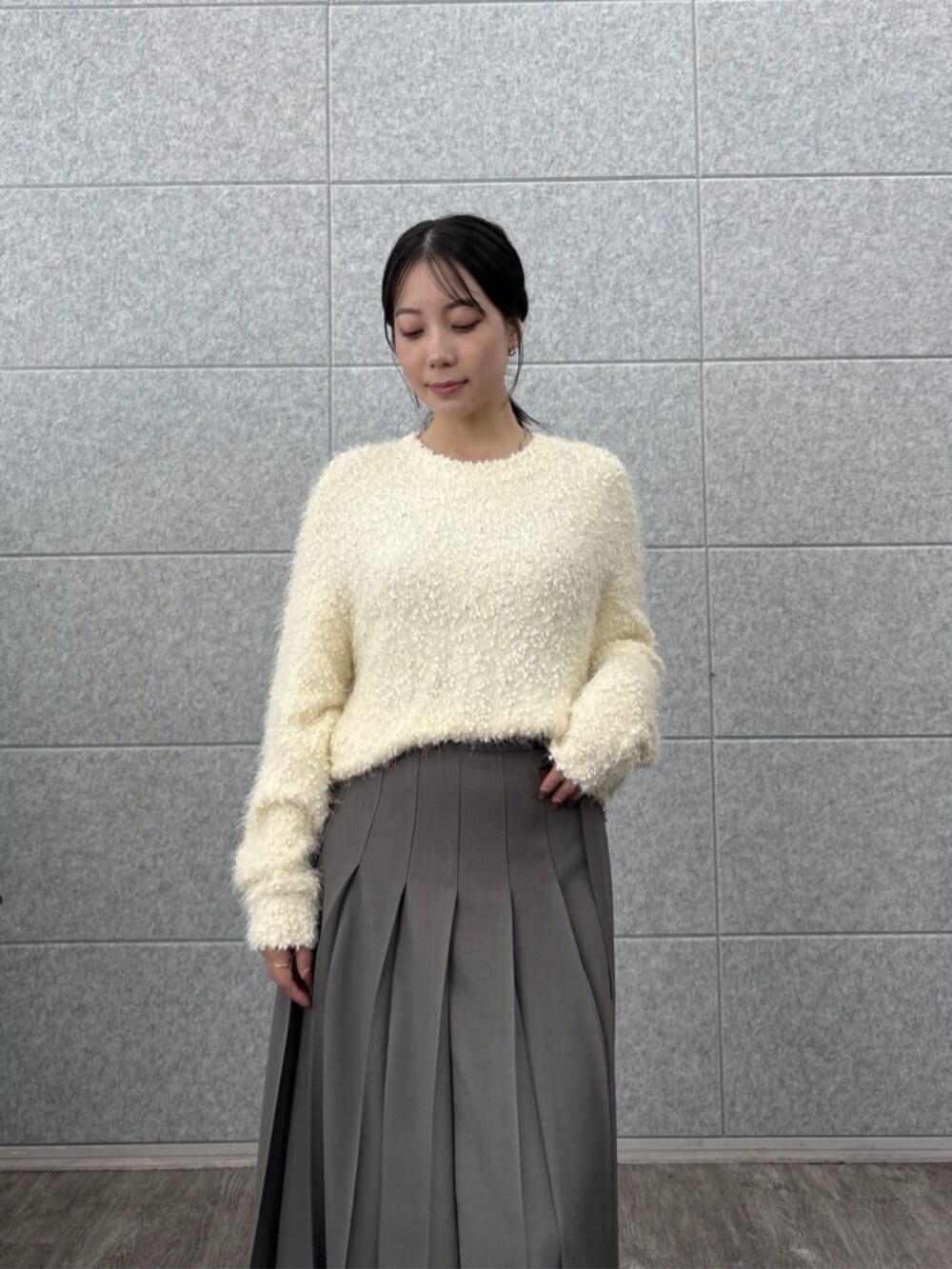 ホワイト系のニット/セーター、グレー系のスカートを着用したレディースの秋コーディネートの7枚目の写真