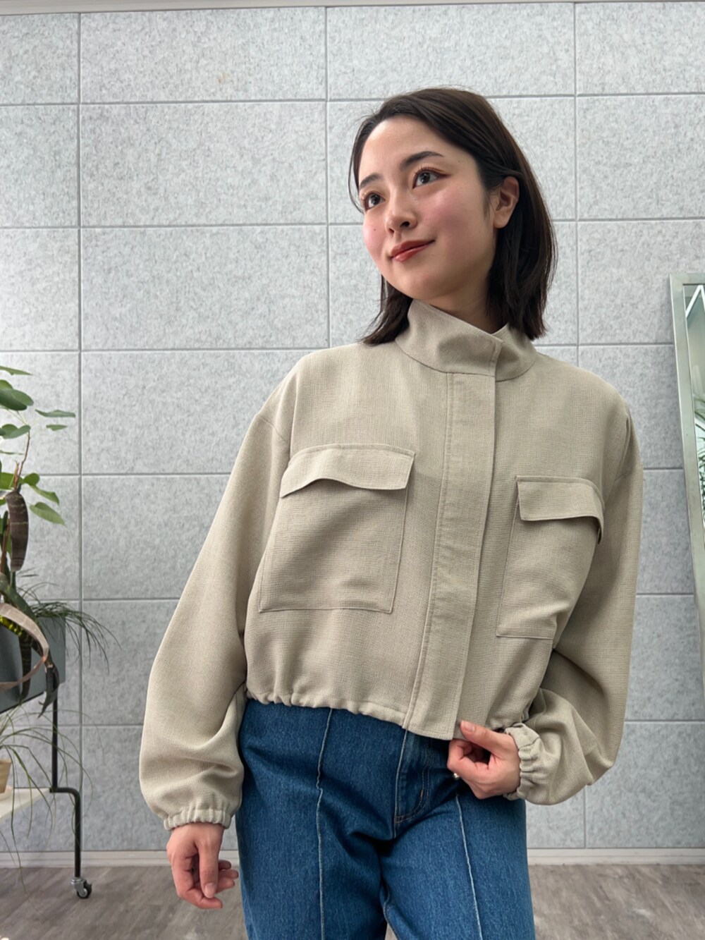 ブルー系のデニムパンツ、グリーン系のブルゾンを着用したレディースの春コーディネートの6枚目の写真