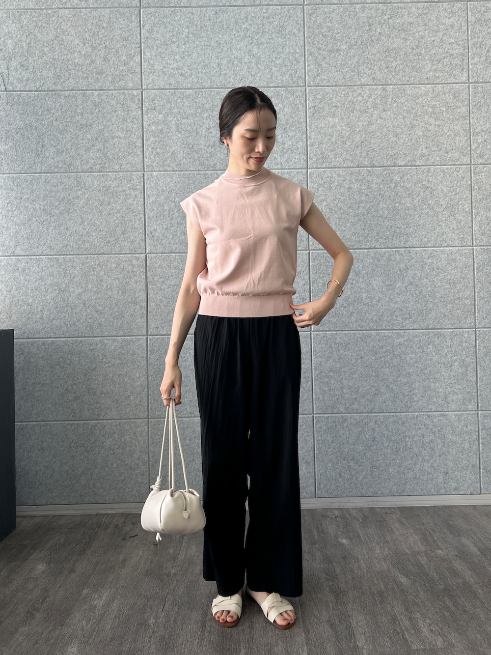 ピンク系のニット/セーター、ブラック系のその他パンツを着用したレディースの夏コーディネートの2枚目の写真