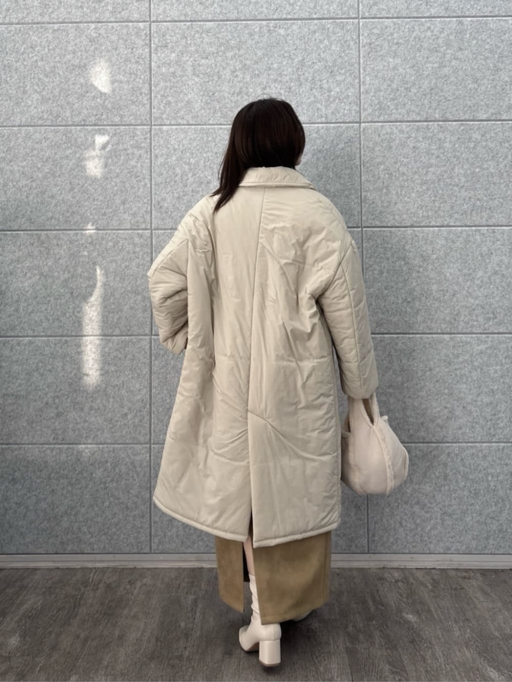 ベージュ系のその他アウター、ブラウン系のスカート、ベージュ系のニット/セーターを着用したレディースの冬コーディネートの4枚目の写真