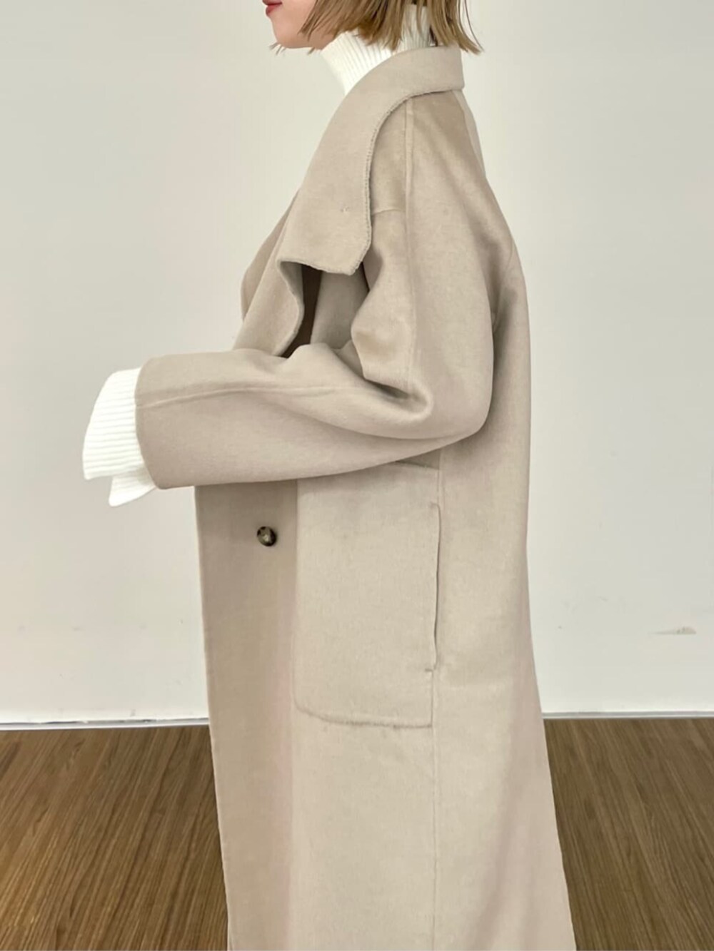 ベージュ系のスカート、ホワイト系のニット/セーター、ベージュ系のその他アウターを着用したレディースの秋コーディネートの7枚目の写真