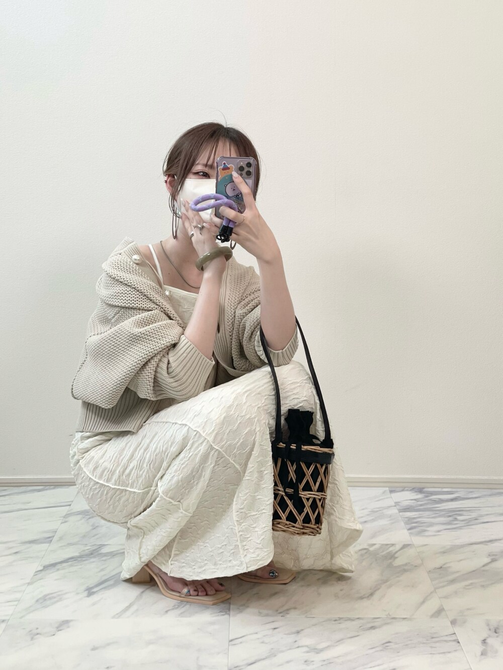 ホワイト系のワンピース、その他のサンダル、ブラック系のかごバッグを着用したレディースの秋コーディネートの2枚目の写真