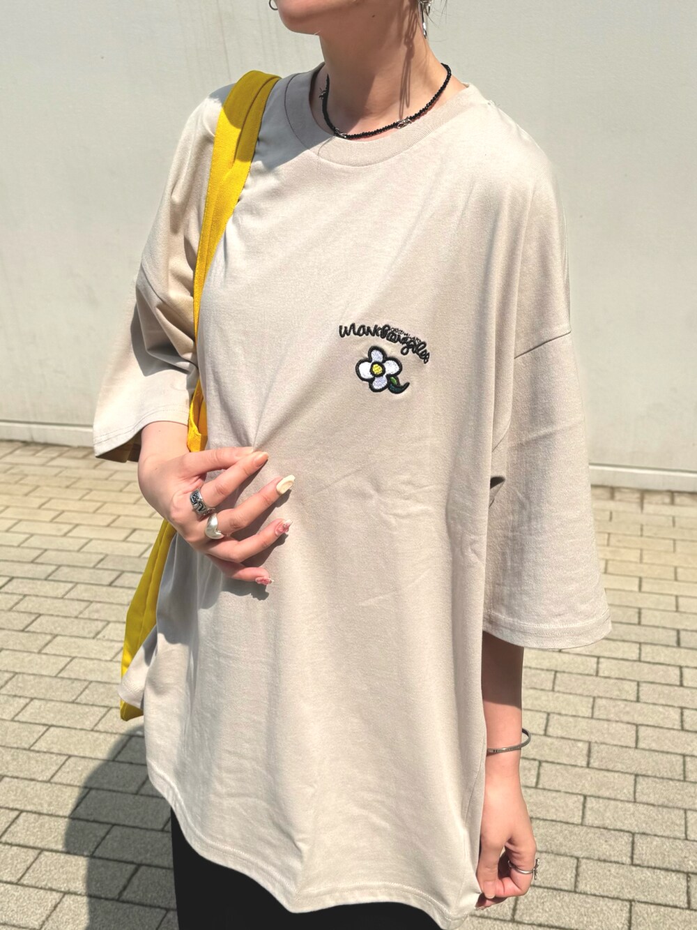 ベージュ系のTシャツ/カットソーを着用したレディースの夏コーディネートの4枚目の写真