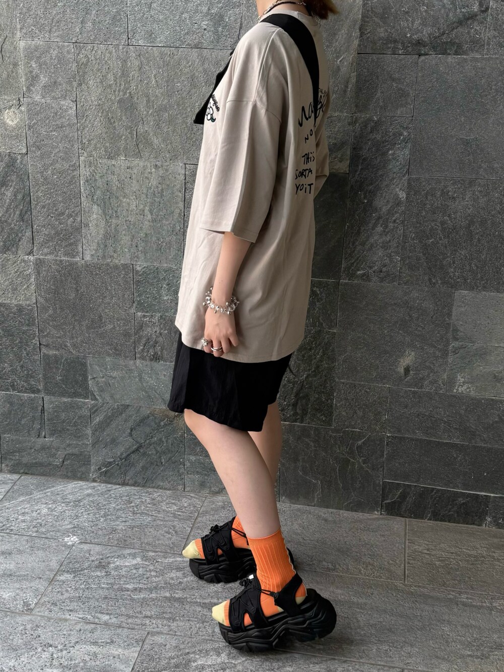 ベージュ系のTシャツ/カットソーを着用したレディースの夏コーディネートの3枚目の写真