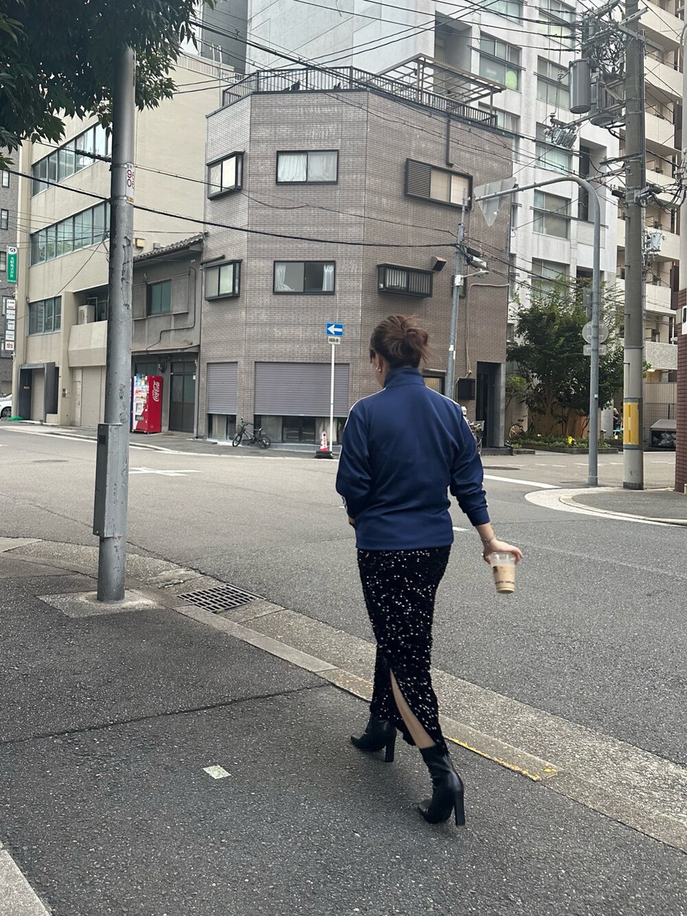 ブラック系のスカート、ブルー系のジャージ、ブラック系のブーツを着用したレディースの秋コーディネートの2枚目の写真