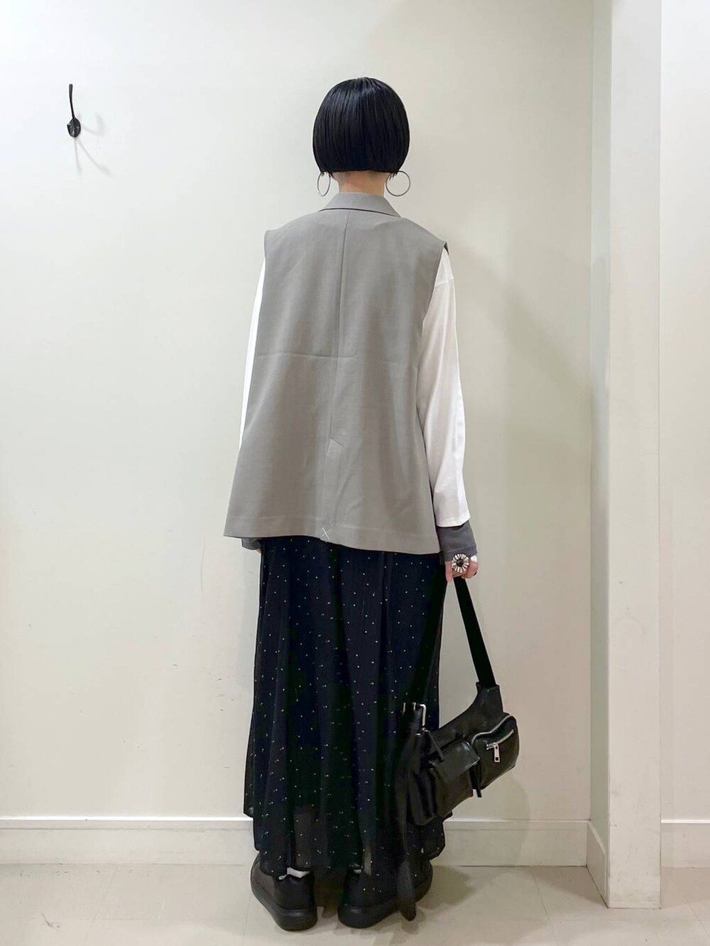 ブラック系のスニーカー、その他のスカート、ホワイト系のTシャツ/カットソーを着用したレディースの春コーディネートの3枚目の写真