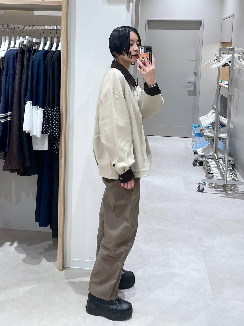 ブラウン系のデニムパンツ、ベージュ系のニット/セーター、ベージュ系のブルゾンを着用したレディースの冬コーディネートの2枚目の写真