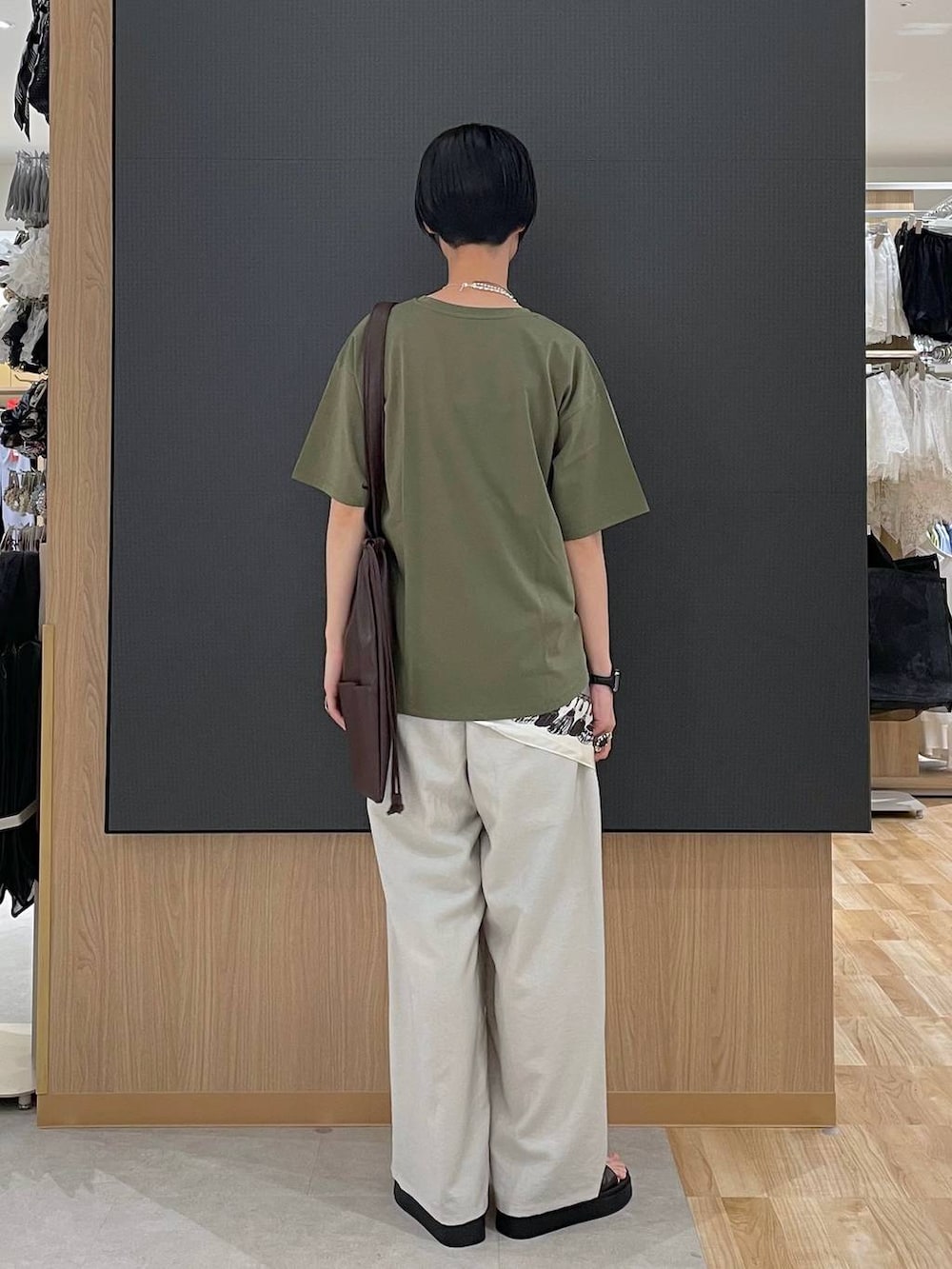 ベージュ系のその他パンツ、グリーン系のTシャツ/カットソー、ブラウン系のサンダルを着用したレディースの夏コーディネートの4枚目の写真