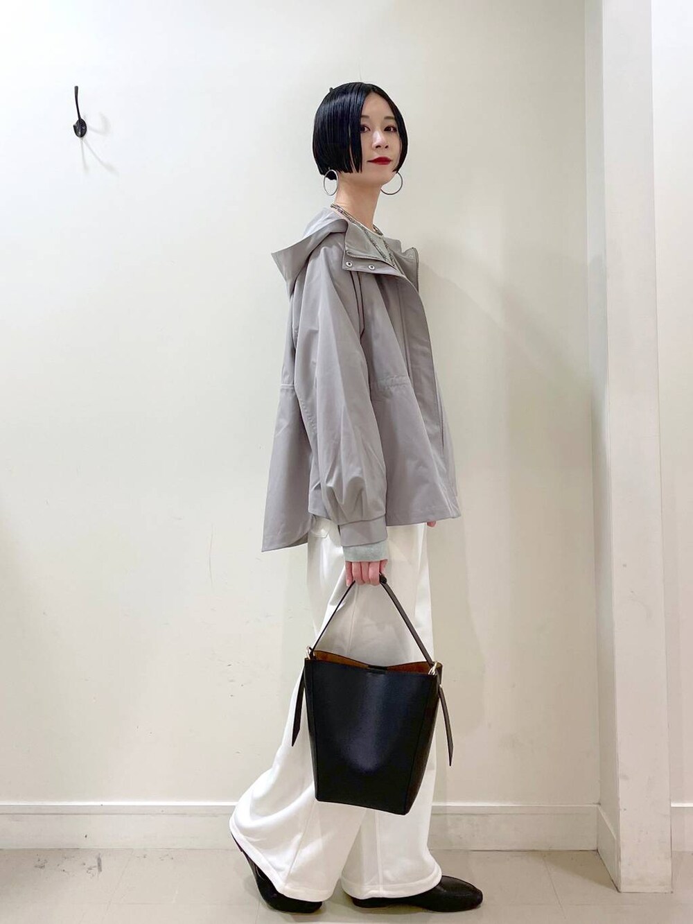 ブラック系のその他シューズ、グリーン系のマウンテンパーカー、ブラック系のショルダーバッグを着用したレディースの春コーディネートの3枚目の写真