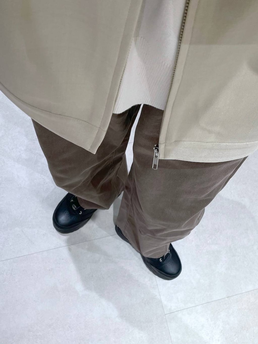 ブラウン系のデニムパンツ、ベージュ系のニット/セーター、ベージュ系のブルゾンを着用したレディースの冬コーディネートの6枚目の写真