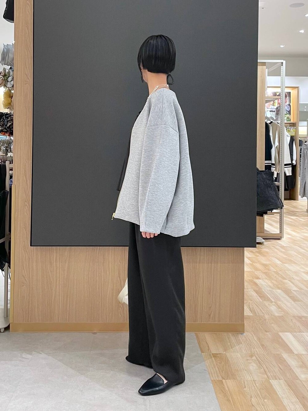 ブラック系のその他シューズ、ホワイト系のショルダーバッグ、グレー系のブルゾンを着用したレディースの春コーディネートの4枚目の写真