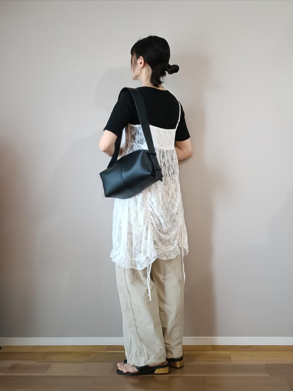 ホワイト系のチュニック、ホワイト系のパンツ、ブラック系のTシャツ/カットソーを着用したレディースの春コーディネートの2枚目の写真