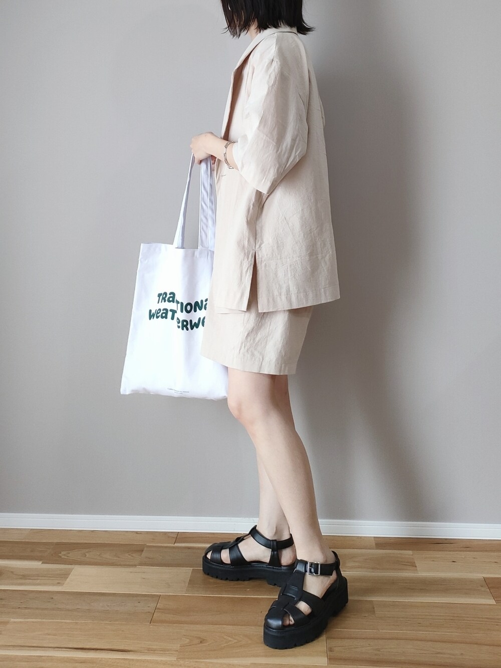 ベージュ系のテーラードジャケット、ベージュ系のその他パンツ、ホワイト系のトートバッグを着用したレディースの春コーディネートの3枚目の写真