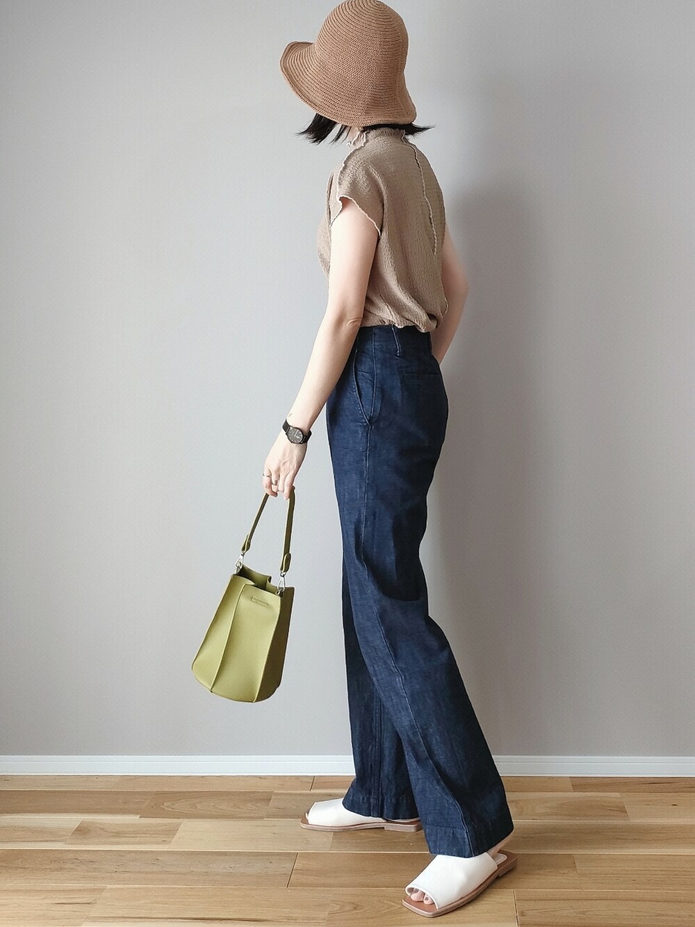 ブラウン系のTシャツ/カットソー、グリーン系のハンドバッグ、ホワイト系のサンダルを着用したレディースの春コーディネートの4枚目の写真