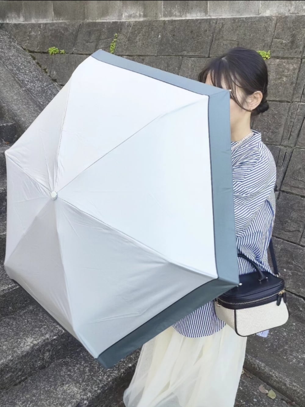 ブルー系のシャツ/ブラウス、ホワイト系のスカート、ブラック系のローファーを着用したレディースの春コーディネートの4枚目の写真