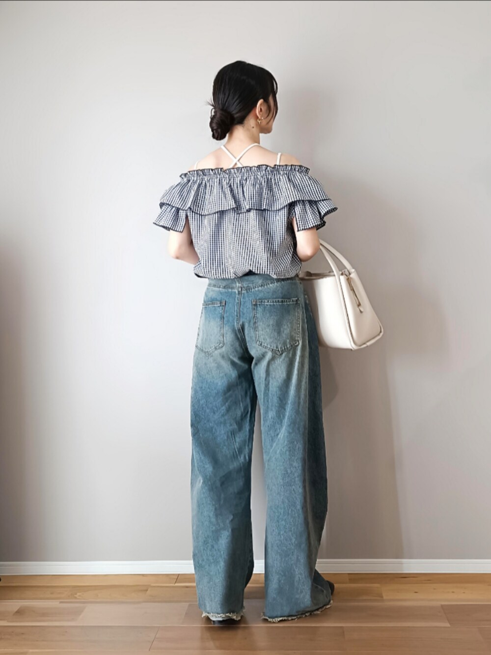 ブルー系のデニムパンツ、ホワイト系のトートバッグ、ブラック系のバレエシューズを着用したレディースの春コーディネートの3枚目の写真