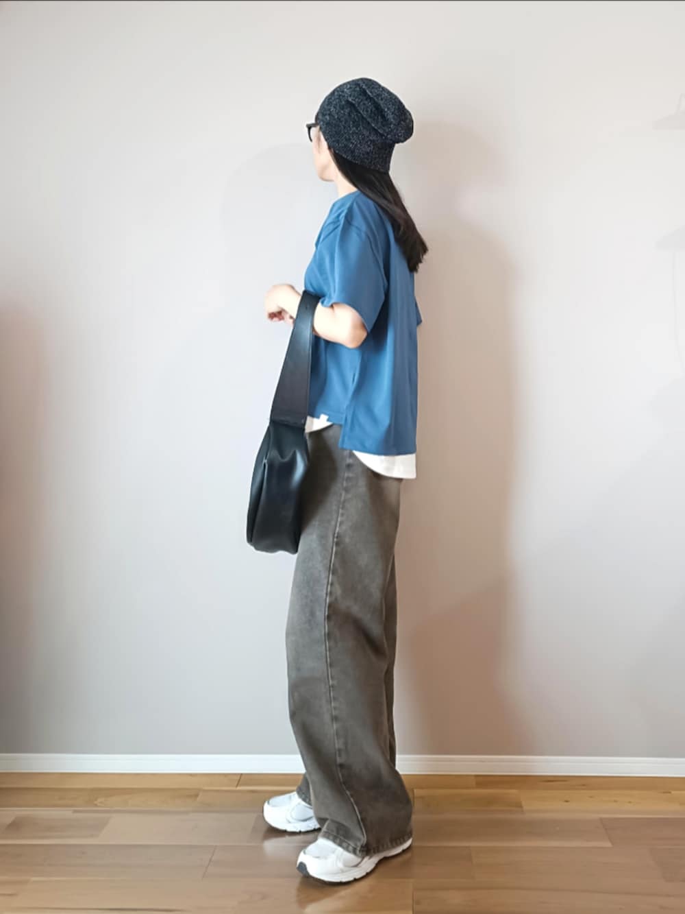 ブルー系のTシャツ/カットソー、ブラック系のデニムパンツ、ブラック系のショルダーバッグを着用したレディースの夏コーディネートの3枚目の写真