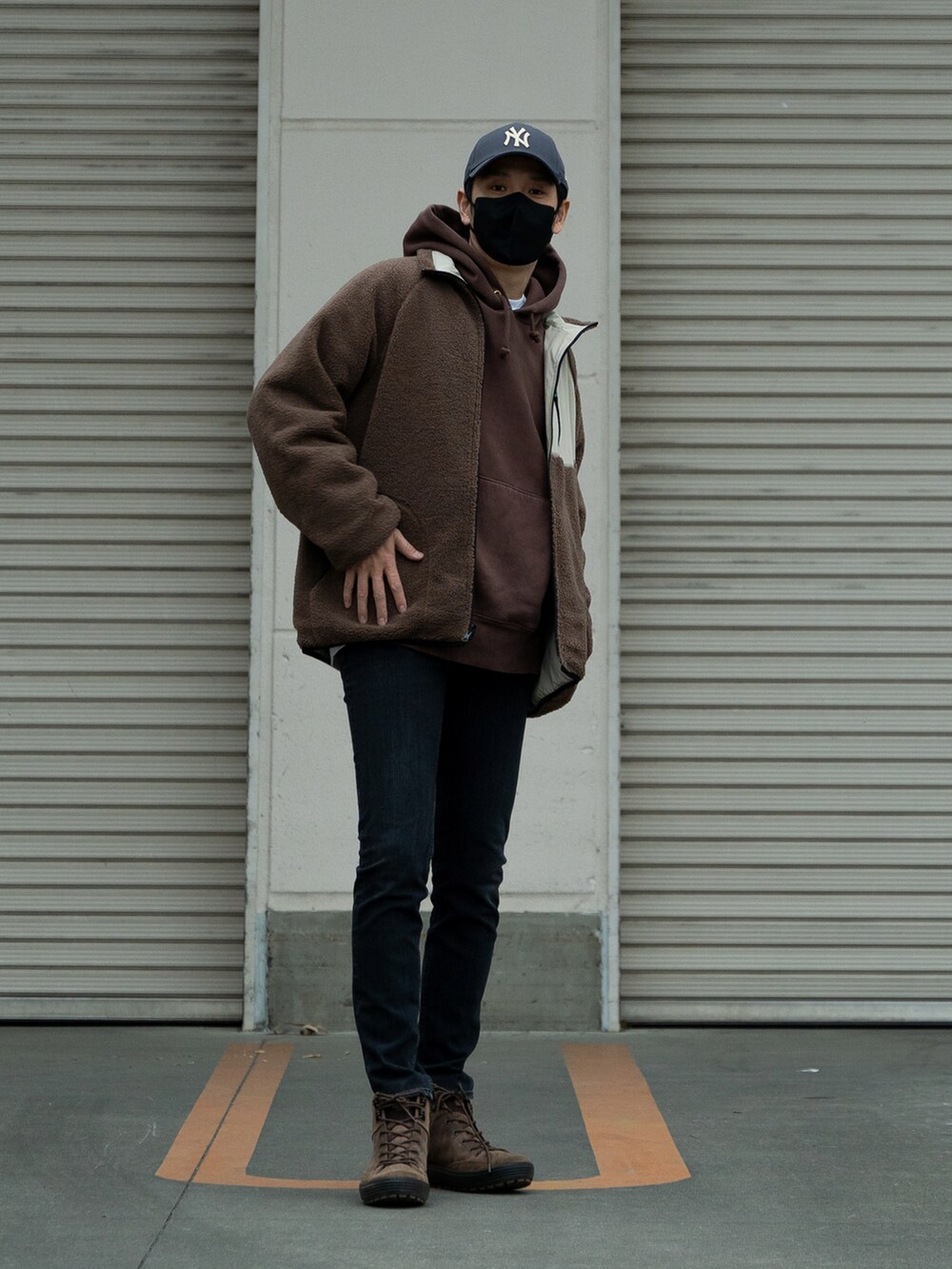 ブラウン系のブーツ、ブラック系のパンツ、ブラウン系のパーカーを着用したメンズの冬コーディネートの2枚目の写真