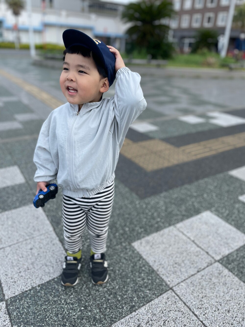 ブラック系のパンツ、シルバー系のブルゾン、ブルー系のスニーカーを着用したキッズの春コーディネートの2枚目の写真