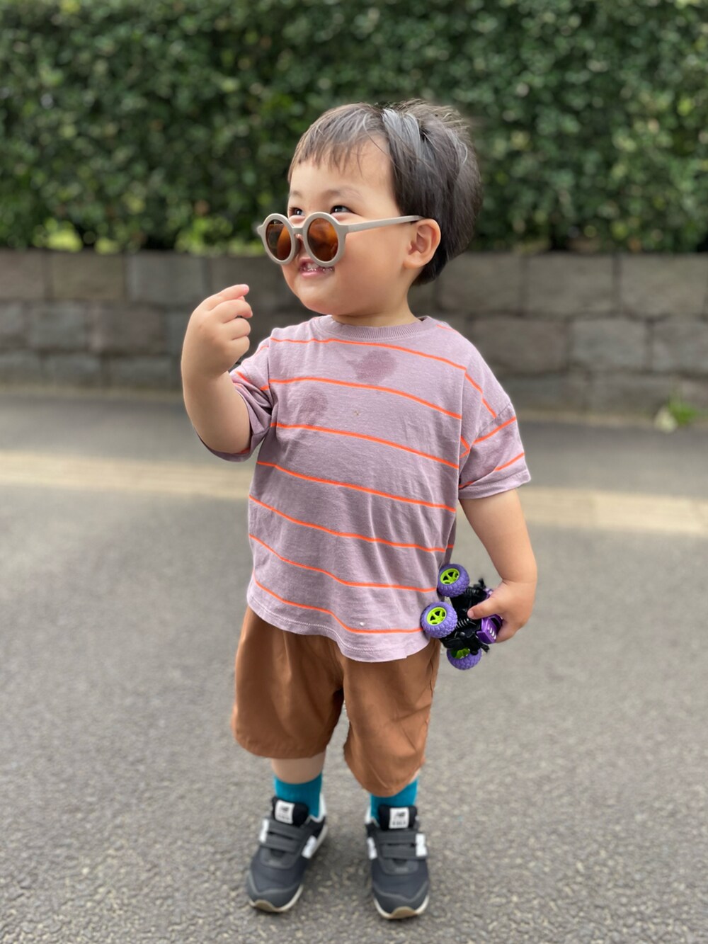 パープル系のTシャツ/カットソー、ブラウン系のパンツ、ブラック系のスニーカーを着用したキッズの夏コーディネートの2枚目の写真