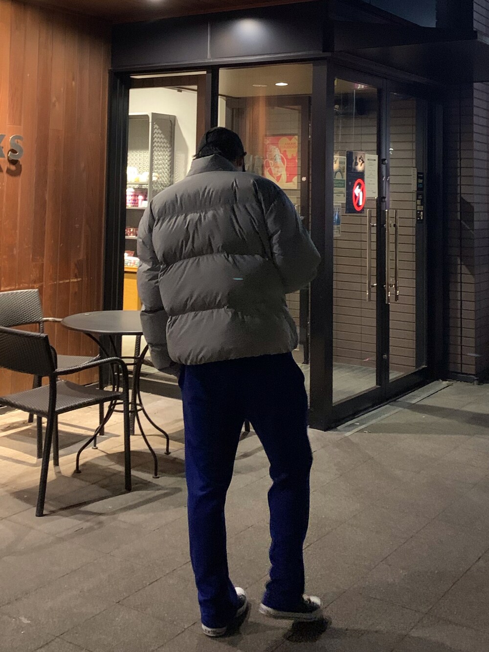 ブラック系のスニーカー、ブルー系のパンツ、グレー系のダウンジャケット/コートを着用したメンズの冬コーディネートの2枚目の写真