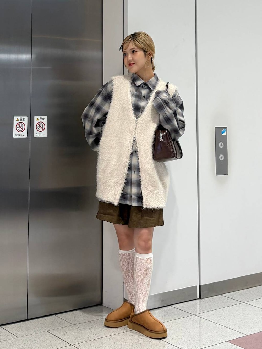 ブラウン系のその他パンツ、ホワイト系のベスト、ブラウン系のその他シューズを着用したレディースの秋コーディネートの4枚目の写真