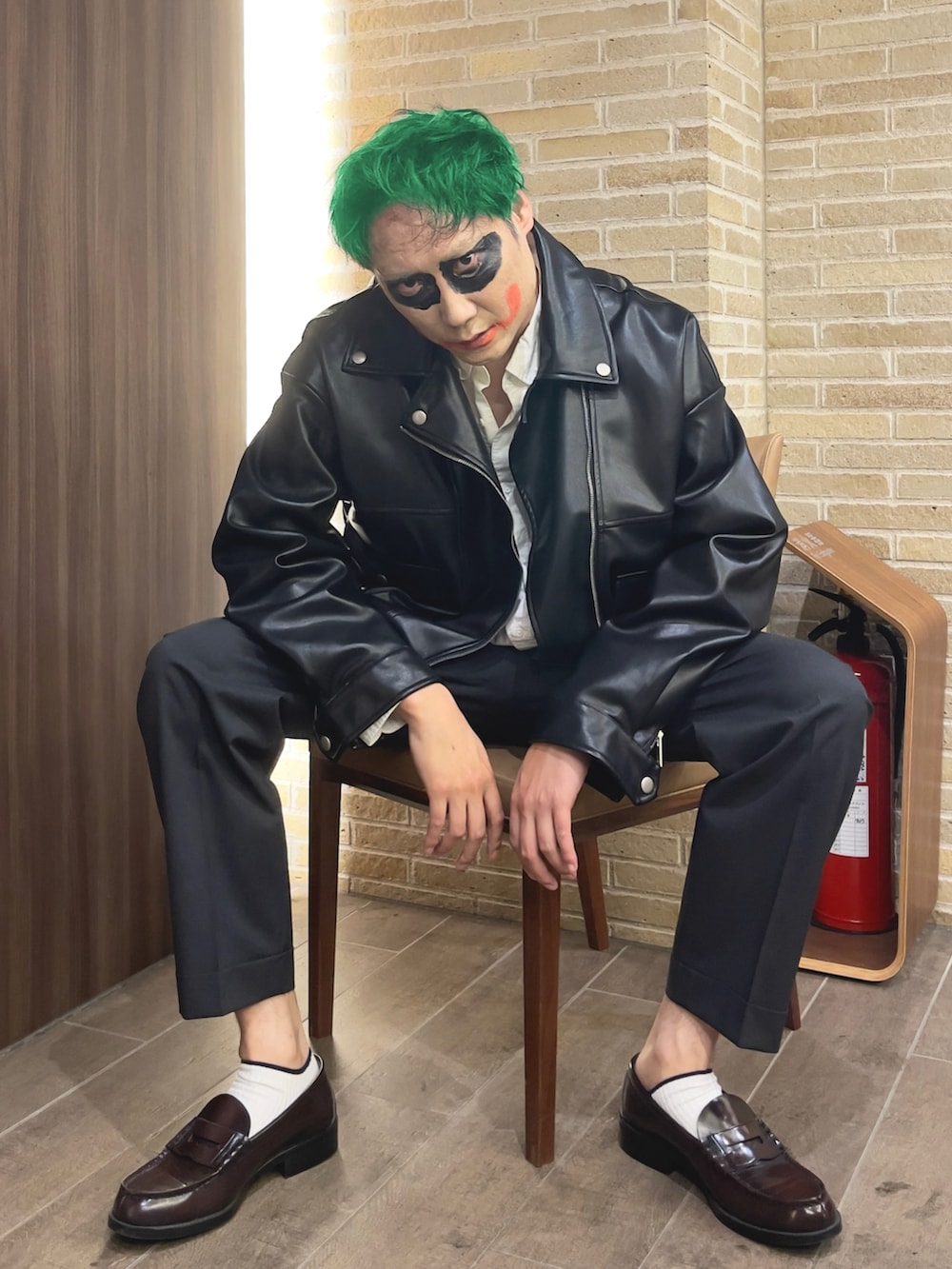 ブラウン系のローファー、ブラック系のライダースジャケット、グレー系のスラックスを着用したメンズの秋コーディネートの2枚目の写真