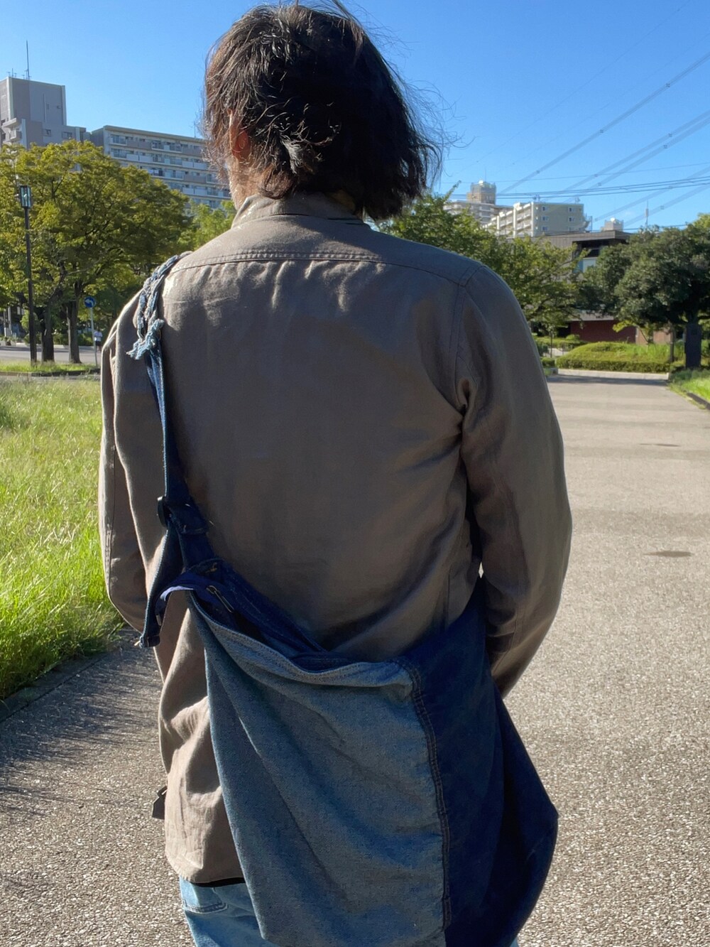 ブラック系のTシャツ/カットソー、その他のテーラードジャケット、ブルー系のショルダーバッグを着用したメンズの秋コーディネートの2枚目の写真