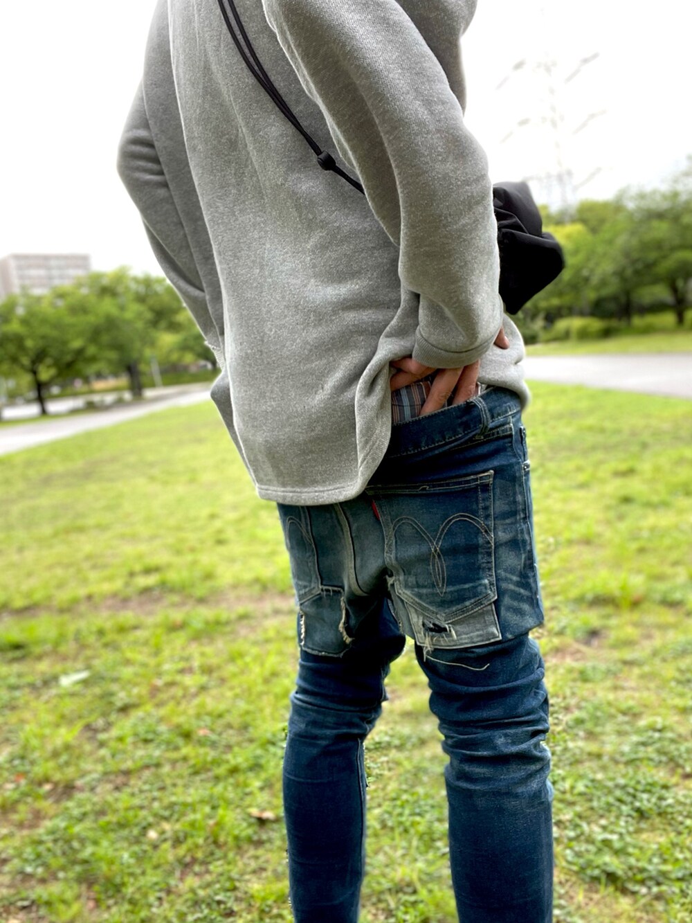 グリーン系のTシャツ/カットソー、グレー系のスウェット、ブラック系のショルダーバッグを着用したメンズの春コーディネートの4枚目の写真