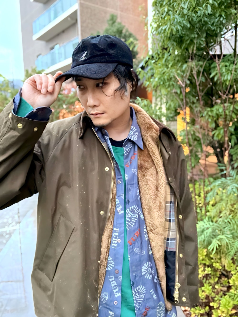 グリーン系のニット/セーター、ブルー系のシャツ/ブラウス、ブラウン系のベストを着用したメンズの冬コーディネートの3枚目の写真