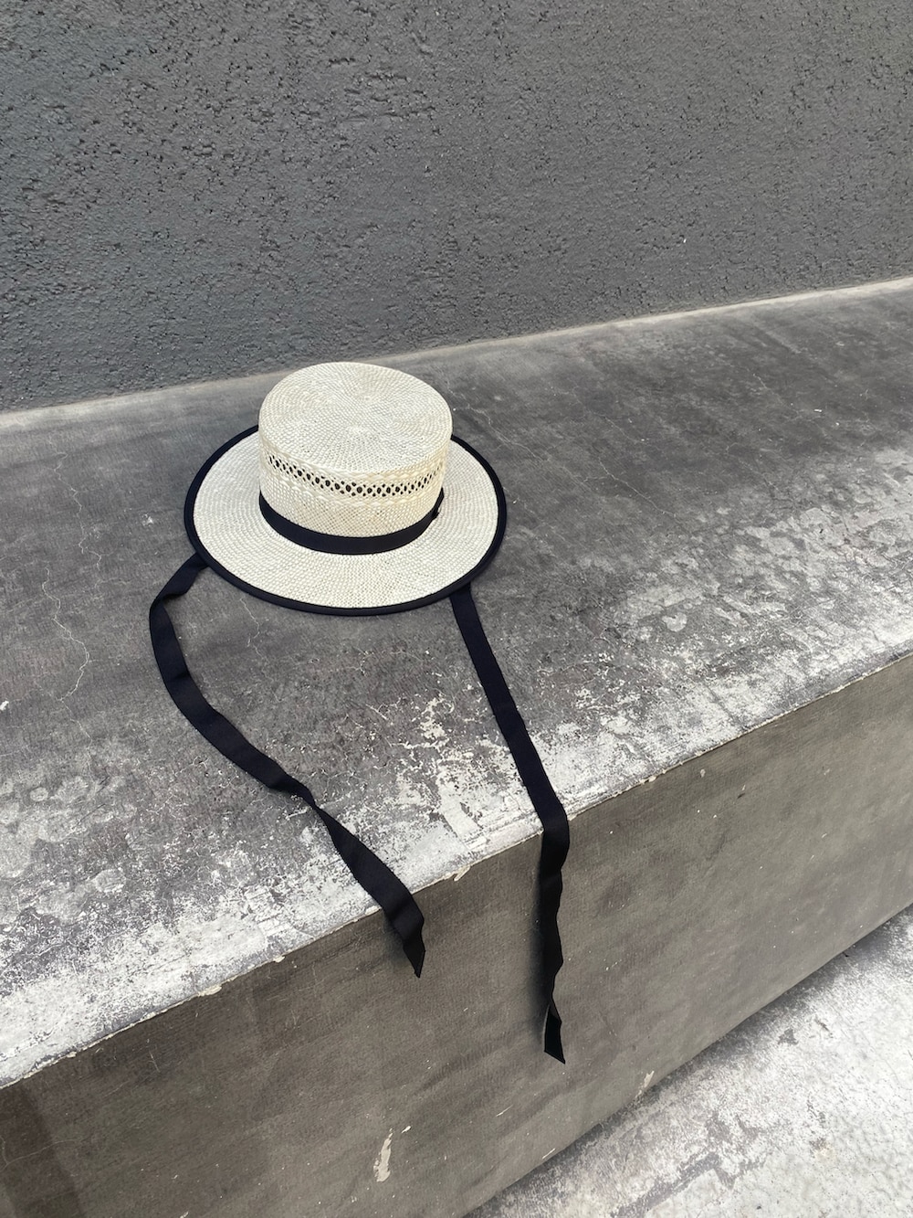 ブラック系のワンピース、ピンク系のスニーカー、ホワイト系のハットを着用したレディースの夏コーディネートの2枚目の写真