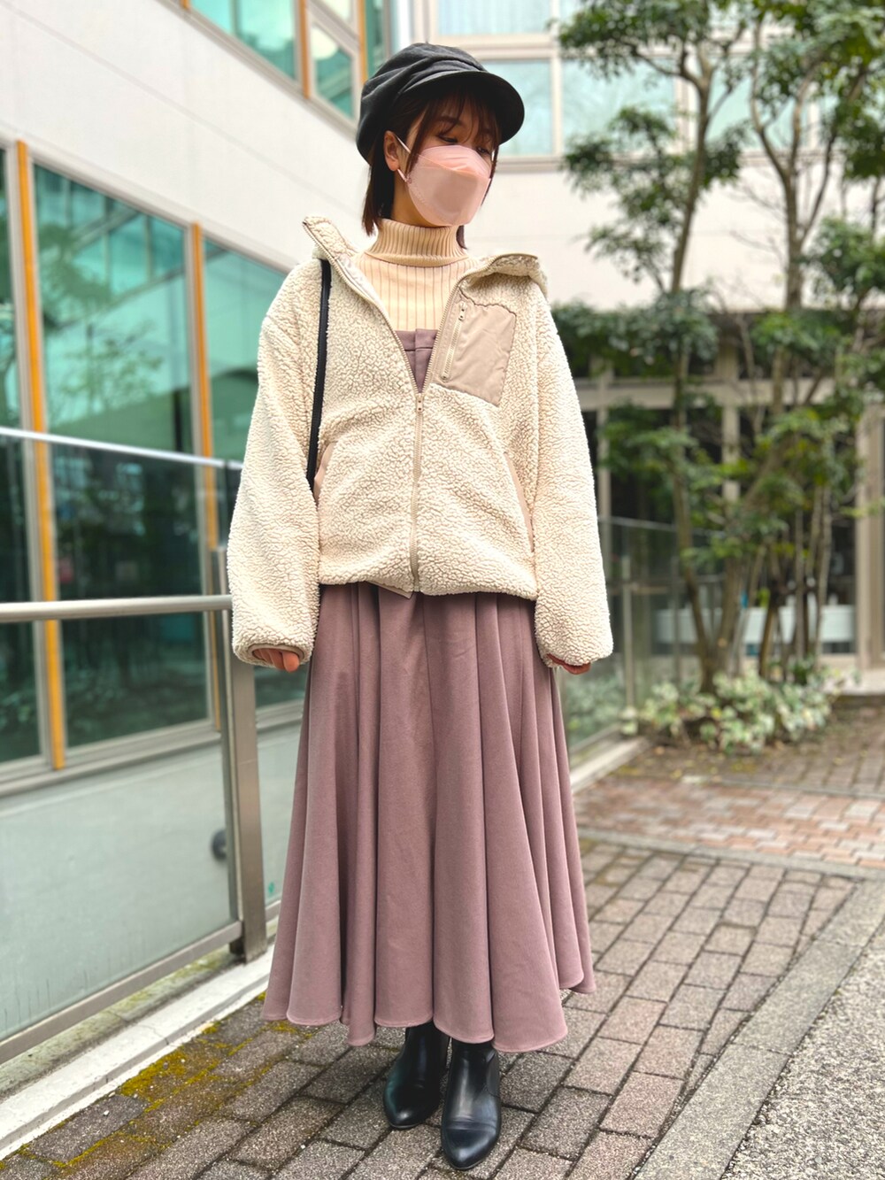 ベージュ系のジャケット/アウター、ピンク系のジャンパースカート、ベージュ系のトップスを着用したレディースの冬コーディネートの2枚目の写真