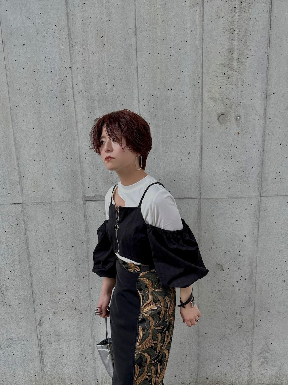 ブラック系のサンダル、ブラック系のスカート、シルバー系のショルダーバッグを着用したレディースの春コーディネートの3枚目の写真