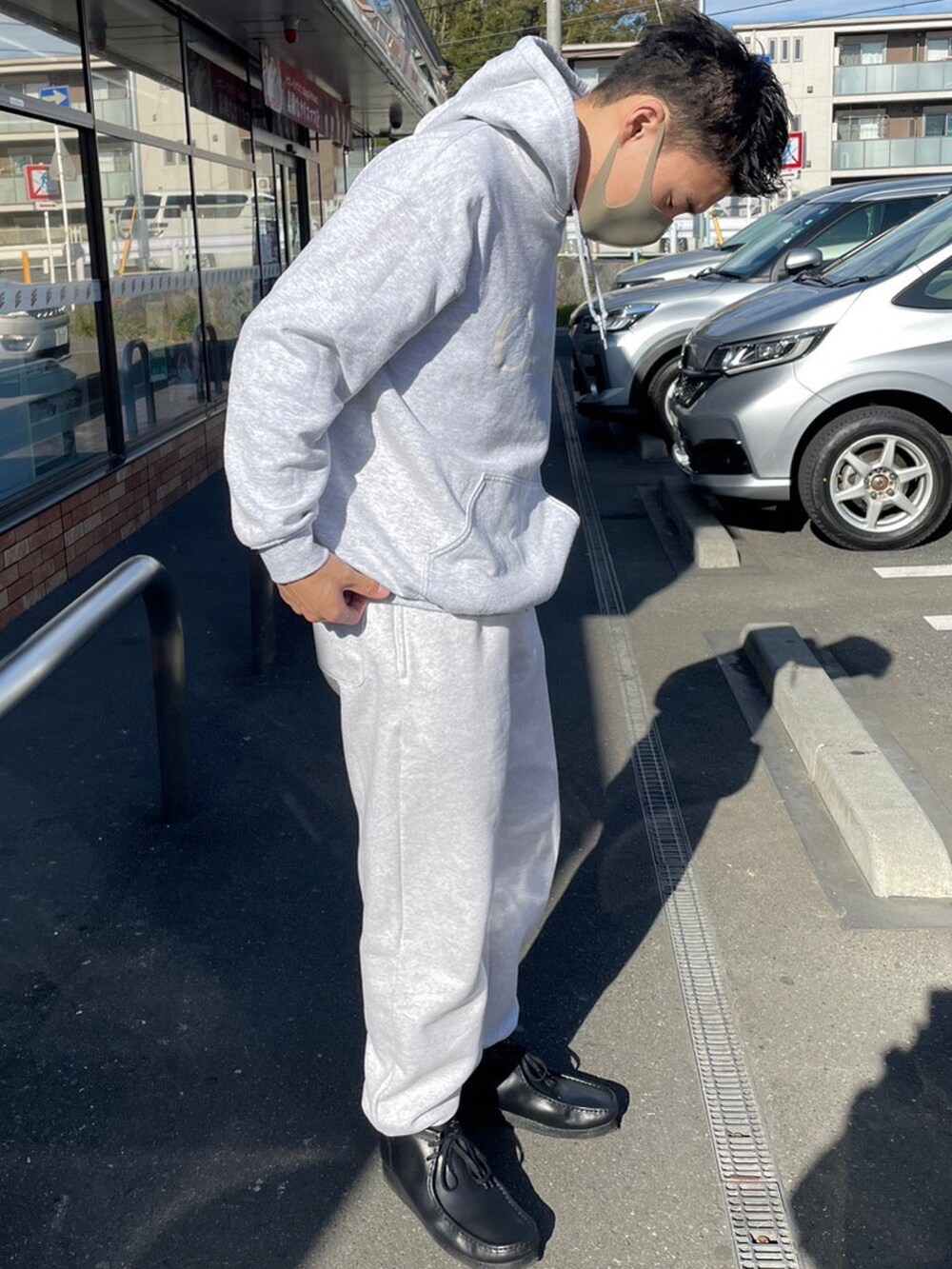 グレー系のパーカー、グレー系のスウェットパンツ、ブラック系のシューズを着用したメンズの冬コーディネートの2枚目の写真